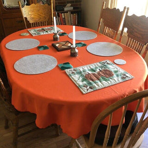 Orange oval tablecloth in a country home during fall
