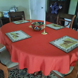 burnt orange oval tablecloth in a farmhouse dining room