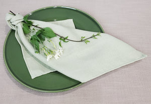 Classic Panama Dinner napkin in white tied with faux leaves