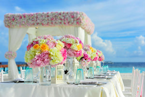 Dreamlike beachfront wedding reception with Havana rental linens and Hydrangeas