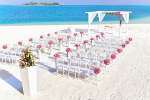 Aisle runner at a lavish beach wedding with beautiful Arc