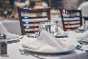 White Havana linen napkins standing on plates