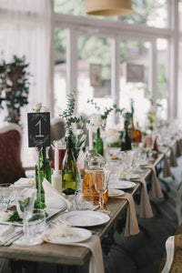 White spun napkins on a gorgeous table with flowers