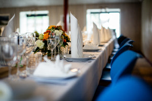 White wedding spun napkins rolled and standing on plates