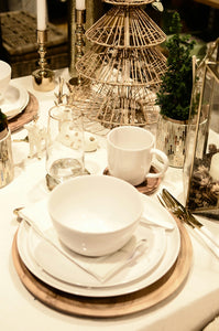 Spun poly napkin under a tea cup on a holiday-themed table