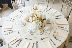 Ivory colored napkins on round table during a classy wedding celebration