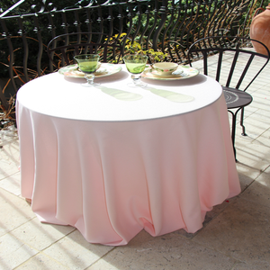 light pink round tablecloth in a garden