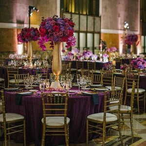 Breathtaking wedding reception with elegant table linens and lavish floral centerpieces