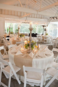 Quality wedding linens at a beautiful outdoor country club-style reception with a wide table runner