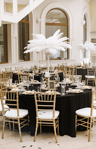 Poly Wedding Table linens at an elegant High-end wedding reception with feather centerpiece