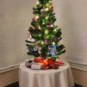 Holiday linens used under a Christmas tree with decorations