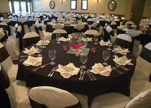 Black table linens on many tables during a banquet hall wedding