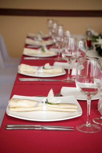 red tablecloth and ivory napkins at wedding