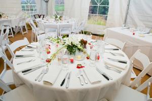 Round Nuptial linens at an outdoor celebration under a tent