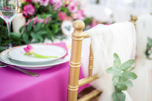 Close-up of a pink tablecloth with a banquette chair