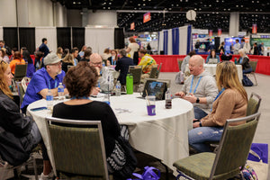 Round table with blank tablecloth at a convention, round table discussion