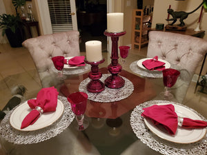Holiday red napkins in silver napkin ring holders.