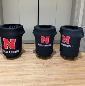 Black Spandex trash can cover's with logo for the University of Nebraska Unions