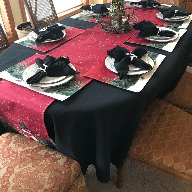 Holiday linens on a home table with a Christmas table runner