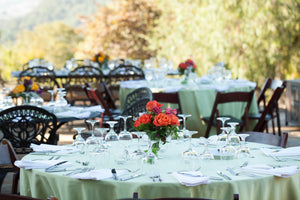 sage round tablecloths at an outdoor wedding