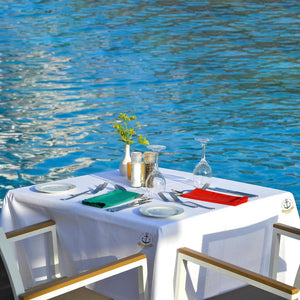 linens on a square table with custom logo by the water