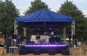 stage and black stage skirt under a tent