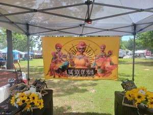 vinyl banner with grommets hanging in a tent at a festival