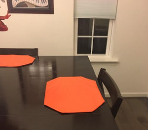 vinyl placemats on a wood dining room table.