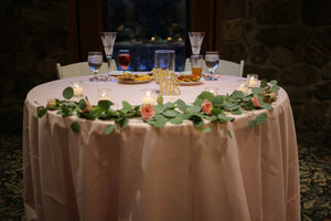 Deluxe table linen on a round couple's table at a small wedding