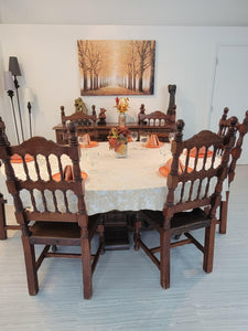 Beautiful fall tablecloth setting with orange dishes and fall decorations