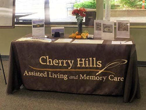 Branded tablecloth with marketing collateral on top for Cherry Hills Assisted living facility