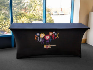 Black stretch fitted table cover with colorful logos for Involvement Works
