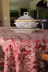 Damask tablecloth with a tea kettle on the table. 