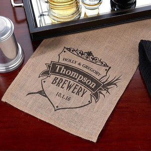 Burlap table runner with a black print for Thompson Brewery