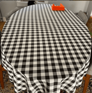 black white ginghan tablecloth on an oval table