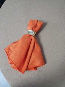 Orange Havana linen napkin with a classic napkin ring 