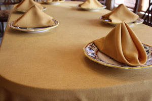 Gold Havana Napkins shot close up on a family lunch table with a matching Tablecloth 