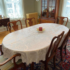 White damask tablecloth on an oval table 