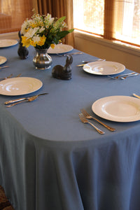 Blue Havana oval tablecloth with plates and silverware 