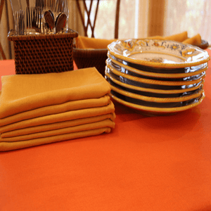 Orange tablecloth and gold cloth napkins, Havana Linen Collection