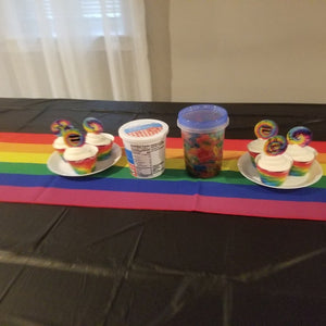 Gay pride table runner on a table with rainbow decorations