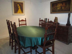 Green Majestic oval tablecloth in a beautiful home with paintings