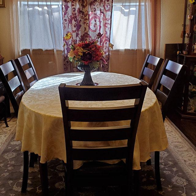 Damask oval tablecloth in a home dining room table 