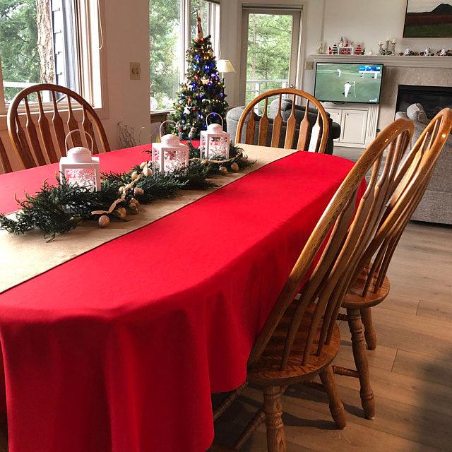 Holiday red oval tablecloth with Christmas decorations