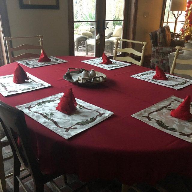 Cherry red Christmas oval tablecloth with cloth napkins and placemats