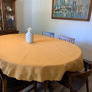 Small oval tablecloth with a ceramic pineapple on the table