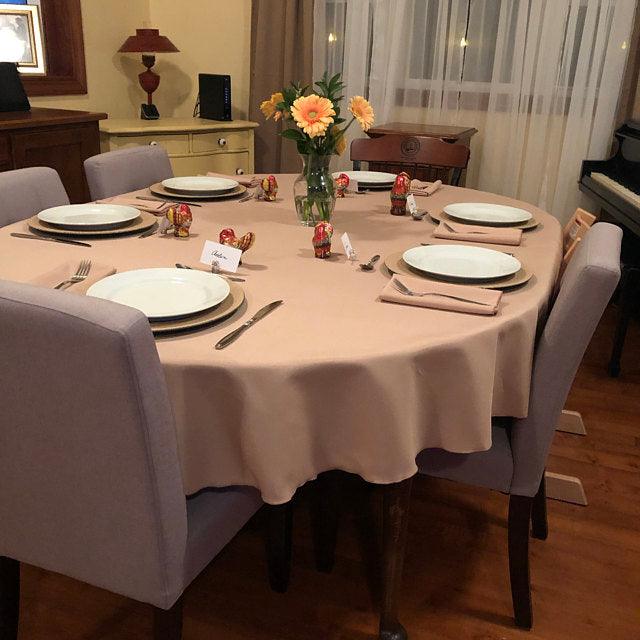 Camel oval tablecloth and cloth napkins in a country home