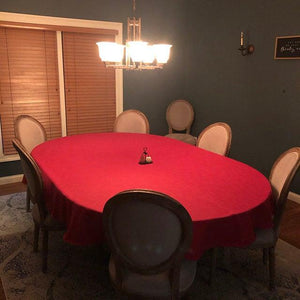 Holiday red oval tablecloth, 6 chairs around the table 