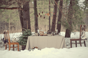 Fine Linens on an outdoor winter Holiday table with a Christmas tree