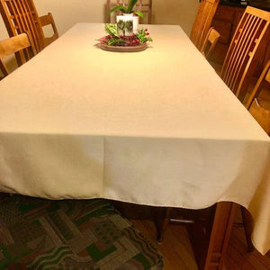 Panama linens on an empty rectangular table in our Buttercup color with a candle